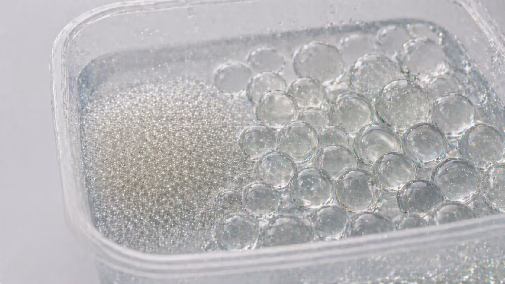Dry and hydrated gel balls showing expansion in water