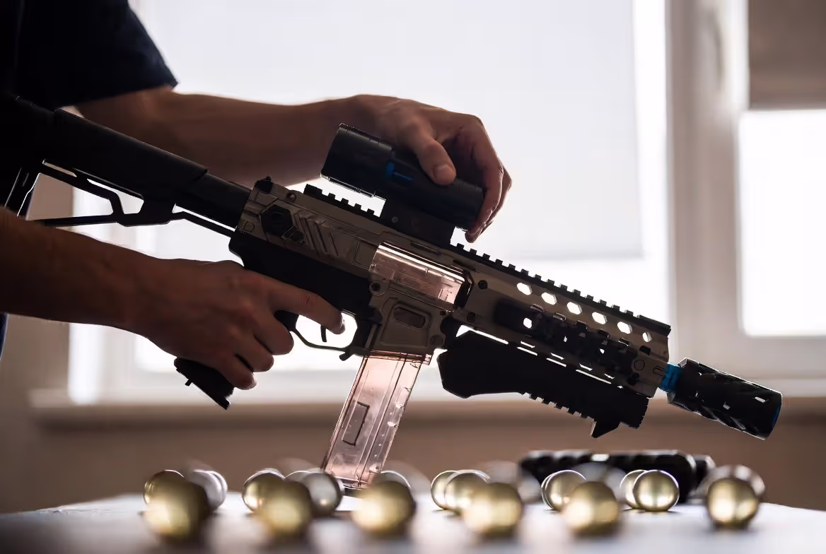 Person preparing gel blaster and loading gel balls before use