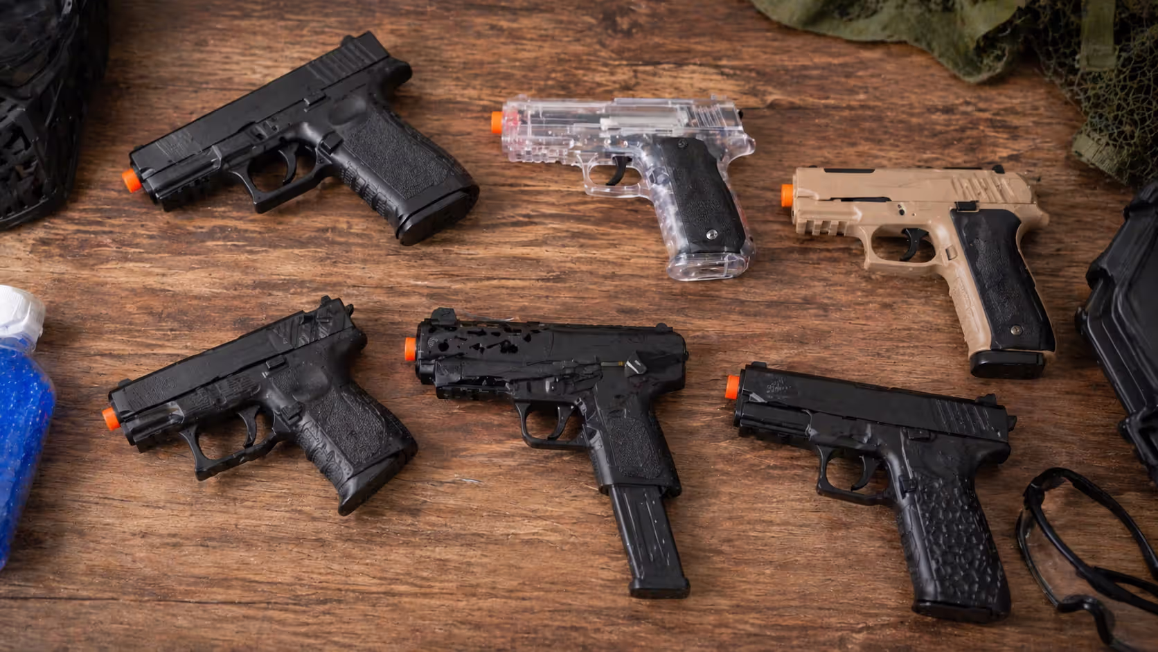 Different compact gel blaster pistols displayed side by side