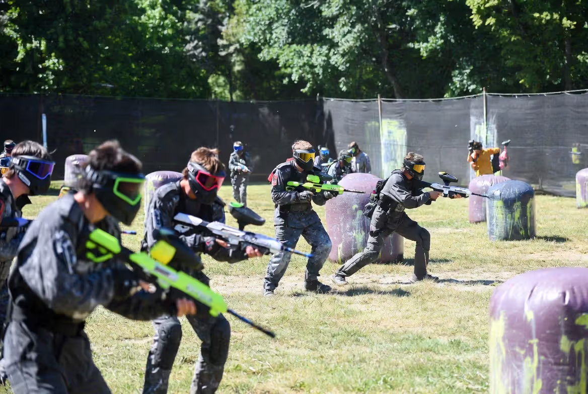 players using gel blasters and paintball guns in different play environments