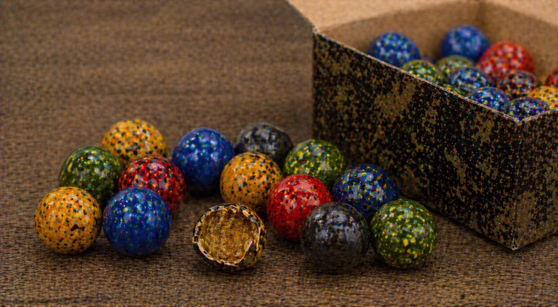 close up of paintballs with one broken showing internal liquid fill